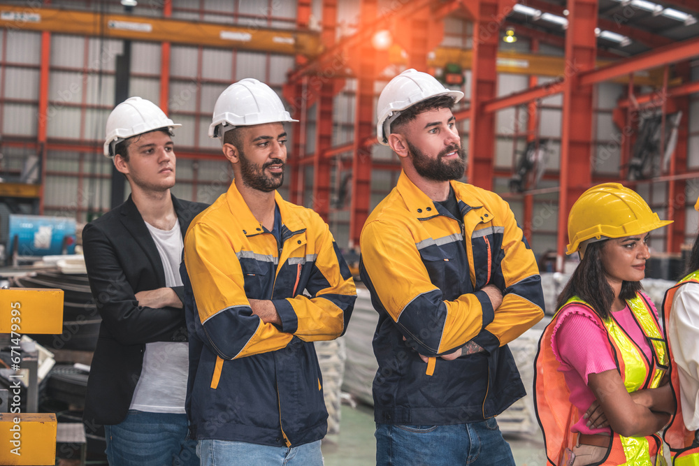 group of male employees, engineers, wearing uniform jackets and helmets for safetyCo-workers meeting ended before the start of production of machinery in the factory. group of male employees, engineers, wearing uniform jackets and helmets for safetyCo-workers meeting ended before the start of production of machinery in the factory.