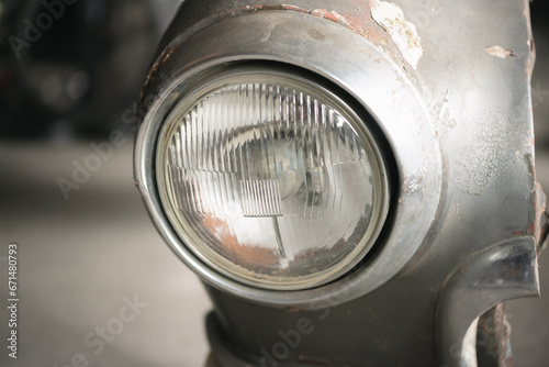 Old retro car headlight close up background.