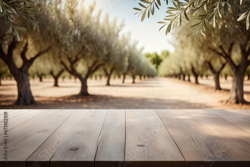 Wooden empty table top, green olive garden trees photo