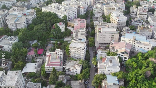 Aerial video of a typical Indian city's and street view with moving car surrounded by trees and buildings, apartements. photo