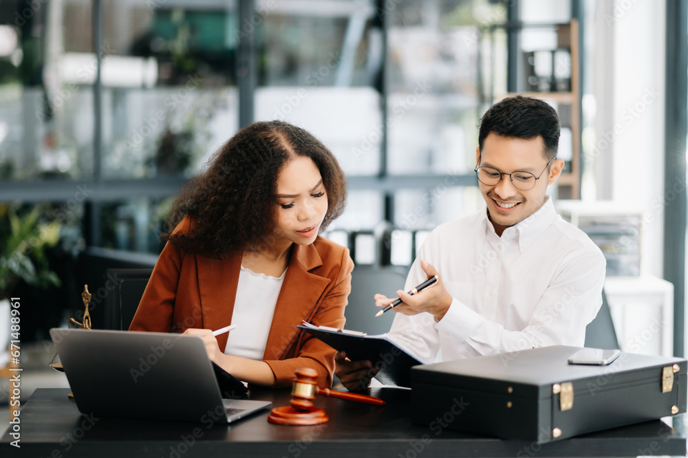 Asian business team and lawyers discussing contract papers sitting at the table. Concepts of law, advice, legal services. at modern office Asian business team and lawyers discussing contract papers sitting at the table. Concepts of law, advice, legal services. at modern office