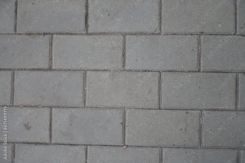 Close shot of running bond brick like gray concrete pavement Close shot of running bond brick like gray concrete pavement