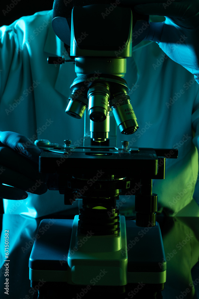 Vertical image scientist using microscope and copy space on black background Vertical image scientist using microscope and copy space on black background