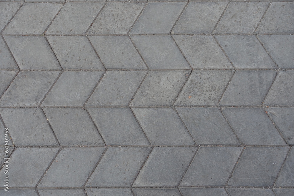 Texture of gray diamond shaped concrete pavement with geometric pattern