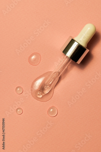 Close up of pipette with drops and copy space on pink background