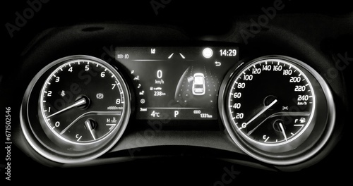 Car speedometer and sensors on a control panel background, car elements close view