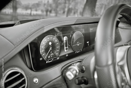 Car steering wheel with car dashboard computer and interior background, modern city car elements close view. Car inside interior © Studio-M
