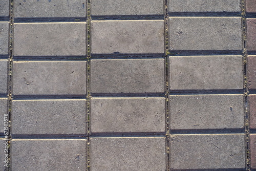 Closeup of stack bond brick like gray concrete pavement