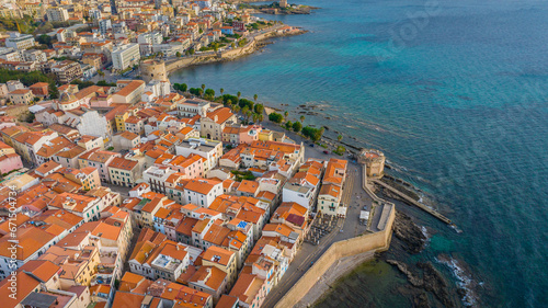 Aerial view of the old town of Alghero in Sardinia. Photo taken with a drone on a sunny day. Panoramic view of the old town and harbor of Alghero, Sardinia, Italy. © Grzegorz