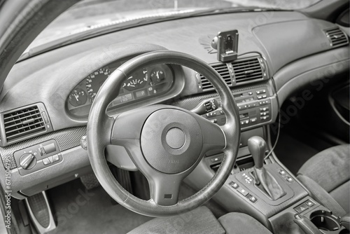 Shift lever, car steering wheel and sensors. Inside a modern car view, city car interior background