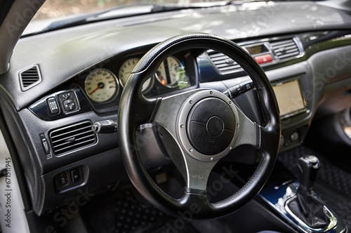 Car steering wheel and car sensors, inerior background, modern city car elements close view. Car inside interior © Studio-M