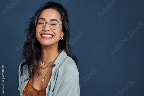 Cheerful young woman with eyeglasses smiling and looking at camera photo