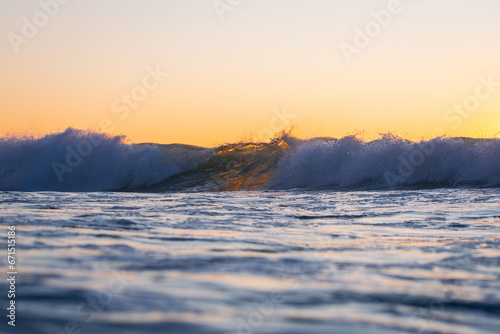 Morning breaking wave in the ocean.