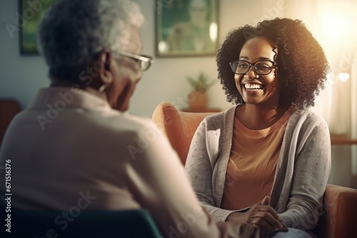 A happy elder talking to their homecare provider about their needs. Healthcare worker or caregiver visiting senior woman indoors at home. Caregiver or healthcare worker visiting senior woman photo