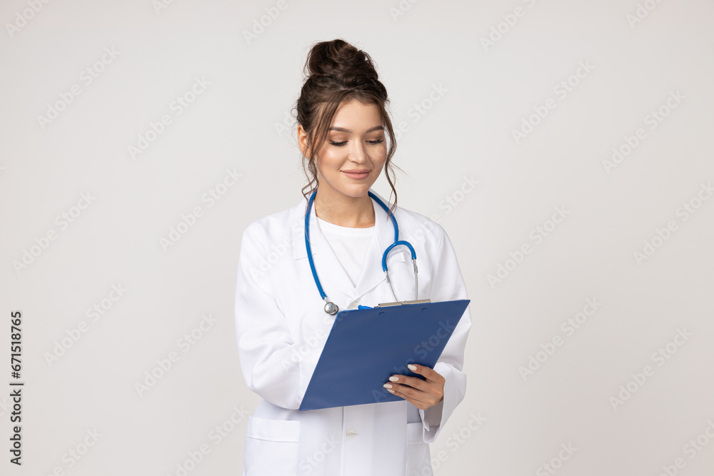Young woman with stethoscope and folder in hands on white background Young woman with stethoscope and folder in hands on white background