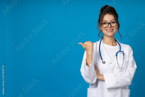 Young woman in glasses with stethoscope on blue background  space for text