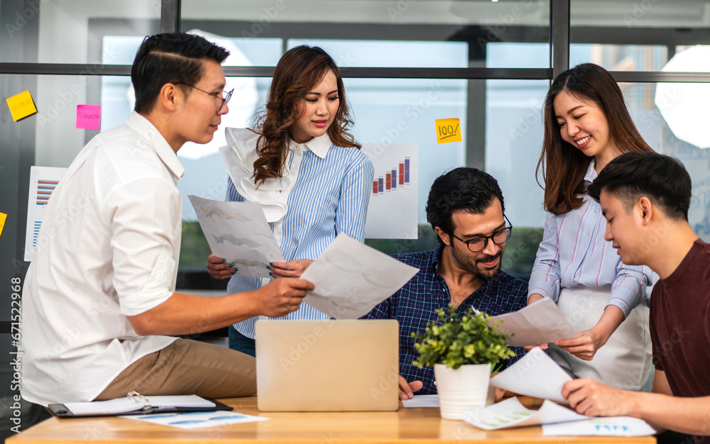 Group of creative asian business meeting and discussing strategy startup project analysis finance process.Success asian business work plan and brainstorm marketing idea with laptop in office.Teamwork