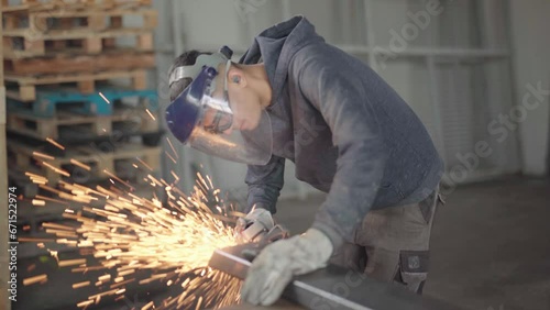 Skilled Worker Using a Grinder for Metal Cutting in Dynamic Poses and Angles, Ready for Action in the Advanced Metallurgical Industry in 4K Quality