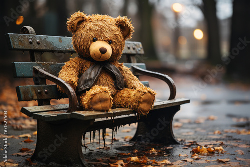 Teddy bear sitting on a park bench, forgotten lonely child toy with wet fur, rainy day