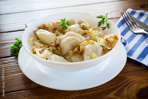Ukrainian Vareniky or Pierogi stuffed with potato and mushrooms, served with fried onion.