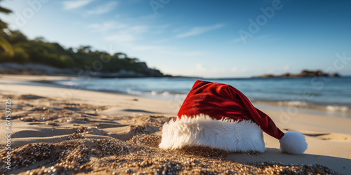 Sant Claus hat on the exotic shore with ocean or sea on background, banner with copy space. Christmas celebration on beach concept photo
