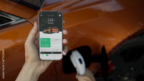 Canvas Print CU Caucasian man using EV application on his phone to check charging status