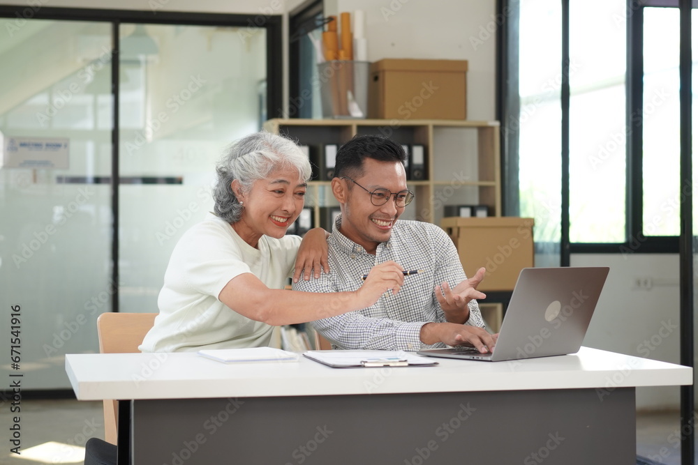 African Asian business man and woman successfully working and talking on the phone with customers African Asian business man and woman successfully working and talking on the phone with customers