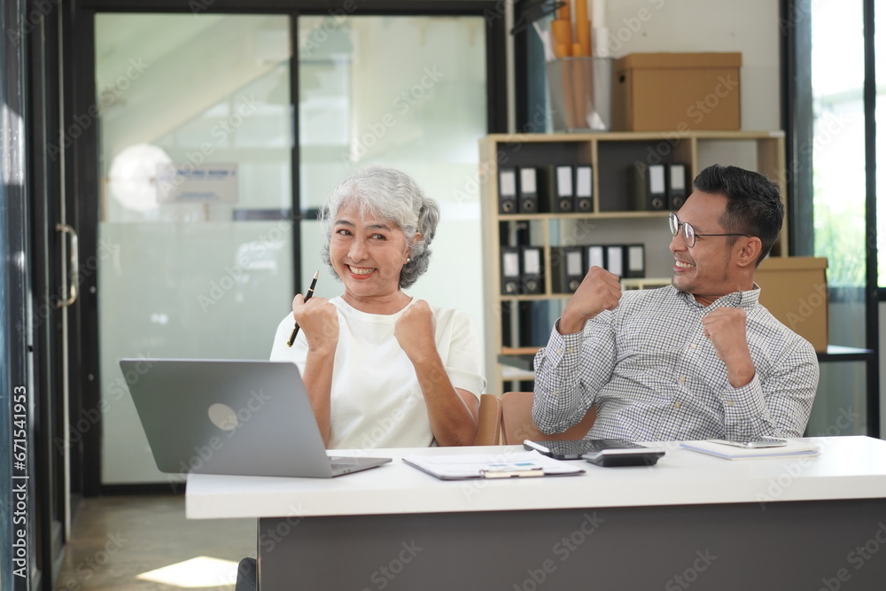 African Asian business man and woman successfully working and talking on the phone with customers African Asian business man and woman successfully working and talking on the phone with customers