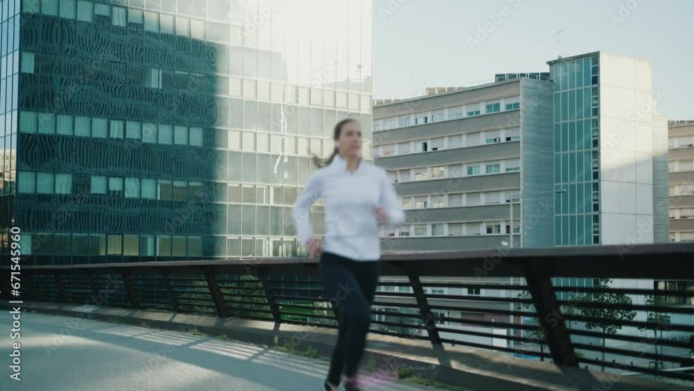 Young woman jogging on bridge in mordern city Young woman jogging on bridge in mordern city