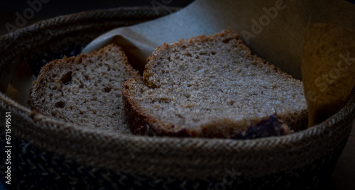 Warm light bathes a paneri overflowing with freshly baked Greek bread.