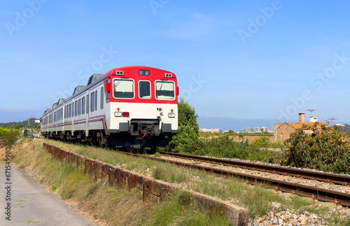 Train on railway. Spain regional commuter train in motion on railway. Spanish National Rail Network. Travel by train in European countries. Train against of mountains drive on railway