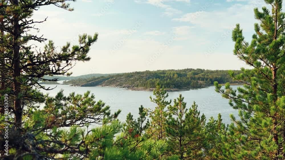Russia, Karelia, Lake Ladoga, Koyonsaari. View of the coast of the island in a cold lake. Beautiful nature of the Republic of Karelia. Stunning panoramic view of the Ladoga Skerry Islands. 4K