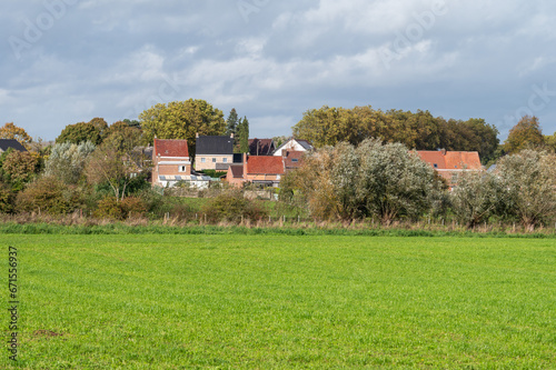 Green farmland and residential houses at the Flemish countryside around Gooik, Belgium