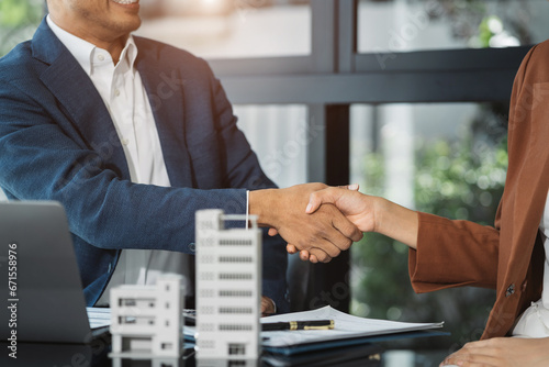 Close up shake hands, Considering buying a home, investing in real estate. Broker signs a sales agreement. agent, lease agreement, successful deal.