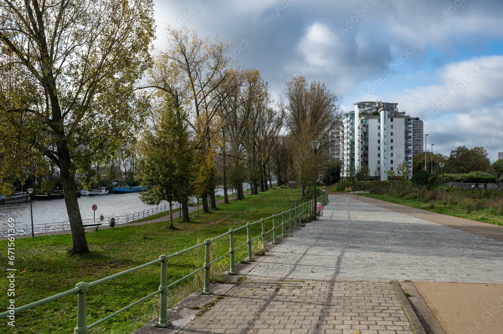 Fototapeta premium Anderlecht, Brussels Capital Region, Belgium - Cycling path and trees at the banks of the canal
