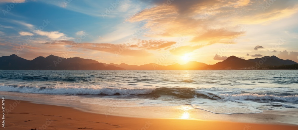 Sunset over the mountains at Pak Meng Beach Thailand