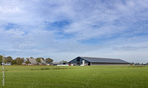 Modern farm between meadows. Ternaard Friesland Netherlands. Husbandry. Cattle barn. Farming. photo
