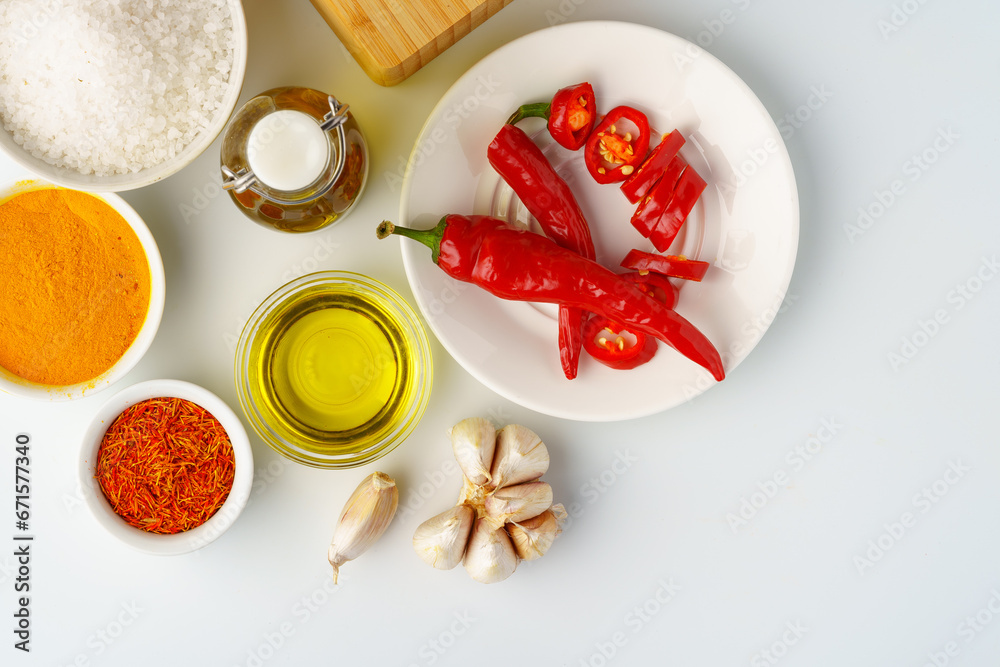 Bowls with spices and cooking ingredients on white background Bowls with spices and cooking ingredients on white background