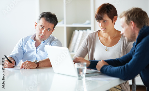 Team, laptop and discussion in business meeting, collaboration and online research for agenda. Business people, teamwork and conversation or communication for proposal, consulting and talking on work