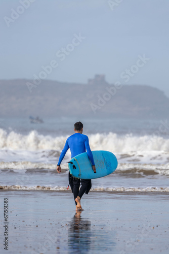 surfer with the surfboard in the beach 