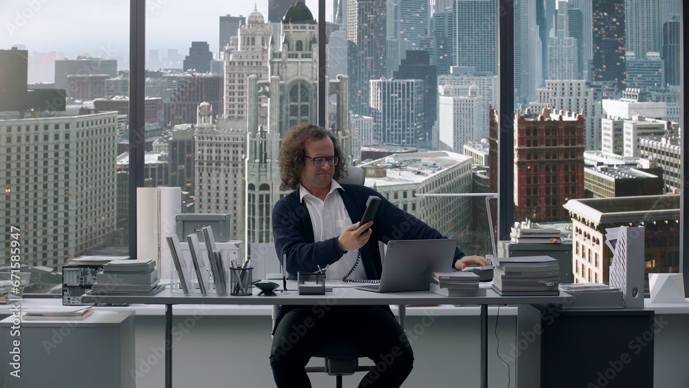 Crazy nerdy looking manager screaming into the phone during the call, negotiations gone wrong Crazy nerdy looking manager screaming into the phone during the call, negotiations gone wrong