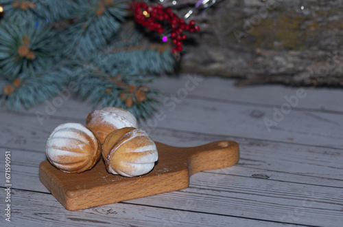 Christmas bakery, shortbread cookies in the shape of nuts sprinkled with powdered sucar, Christmas bakery, shortbread cookies in the shape of nuts sprinkled with powdered sucar, mandarins photo