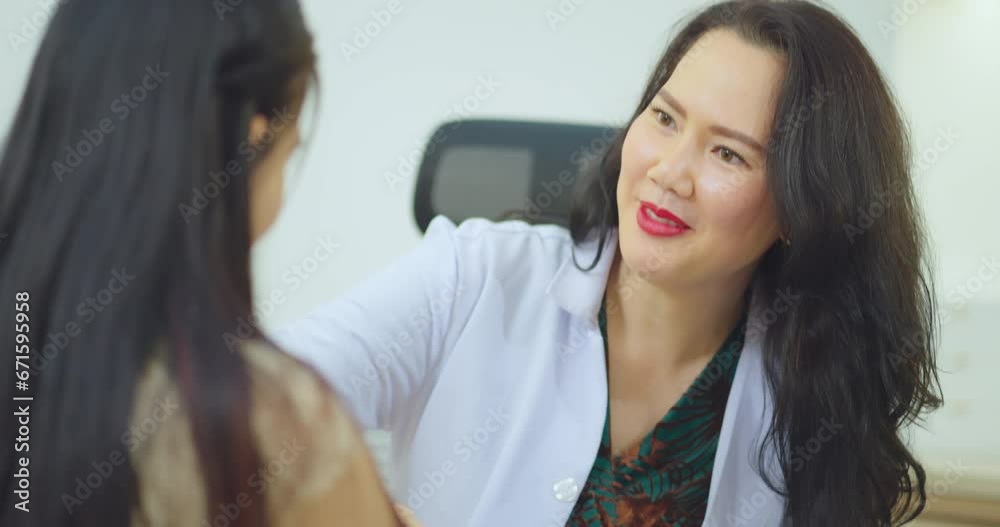 Female doctor talking with female patient at hospital room. They discussing about Illness with female patient at hospital. Female doctor talking with female patient at hospital room. They discussing about Illness with female patient at hospital.