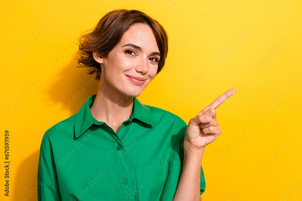 Closeup portrait of cute business lady showing empty blank copy space novelty product isolated yellow color background Closeup portrait of cute business lady showing empty blank copy space novelty product isolated yellow color background