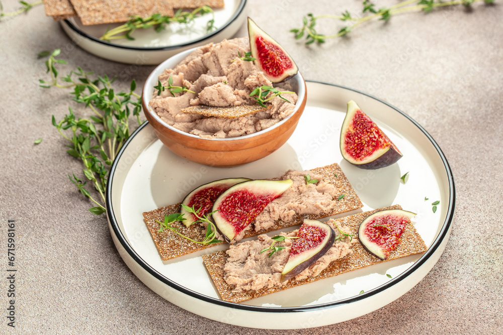 Liver meat pate spread with fig, breakfast on a light background top view. copy space