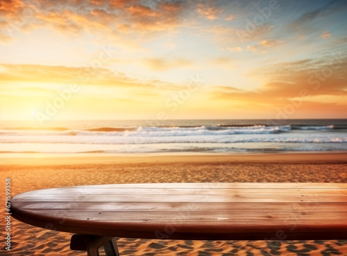 Table with wooden surfboard on the  beach at sunrise.