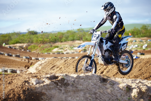 Fotografía Man, motorcycle or off road race track jump as professional person in action danger, competition or fearless