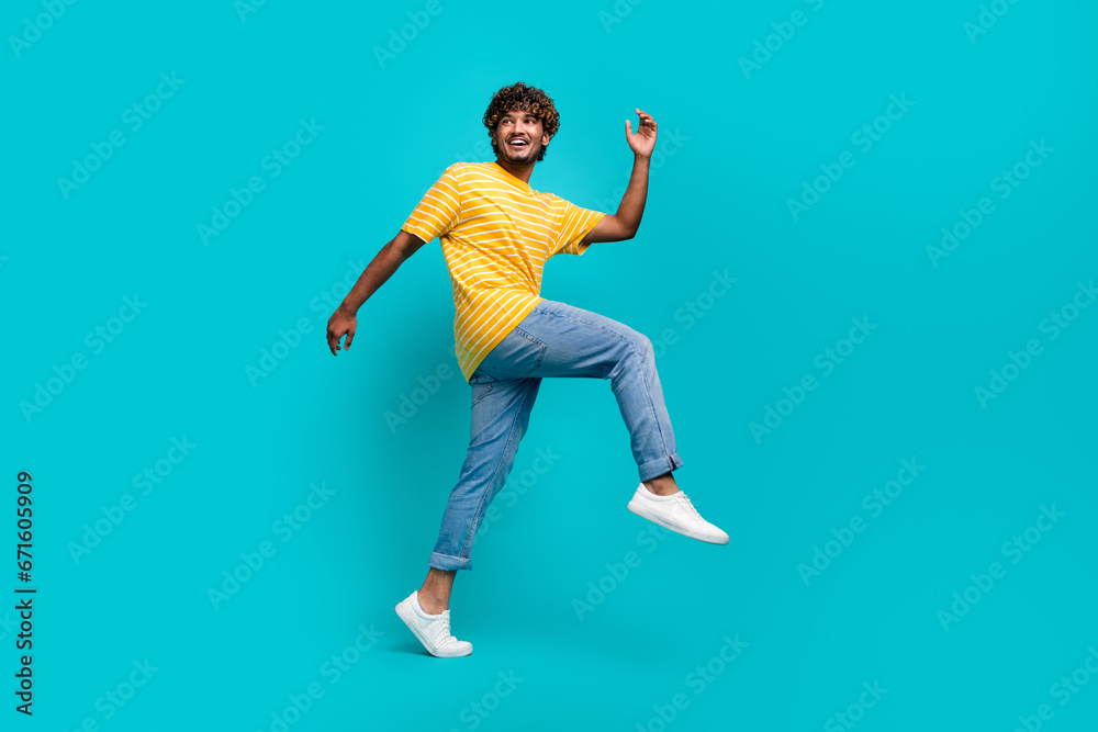 Full size portrait of positive nice person walk look empty space advert isolated on turquoise color background