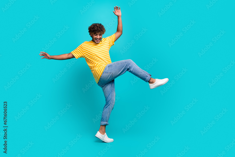 Full body portrait of carefree cheerful man have good mood dancing partying isolated on teal color background Full body portrait of carefree cheerful man have good mood dancing partying isolated on teal color background