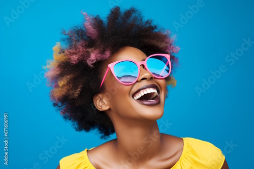 Beautiful African Woman in Sunglasses Radiating Positivity on a Playful Blue Wall Background.